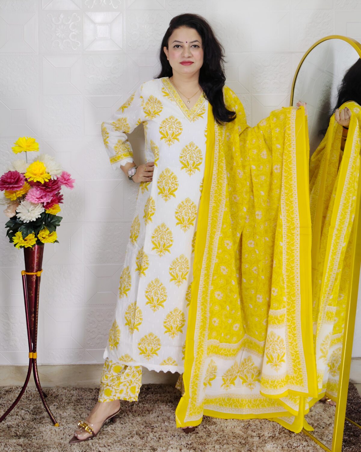 Woman wearing Off White and Yellow Printed Premium Cotton Straight Kurta Suit Set with Inner Lining, Matching Pants and Dupatta