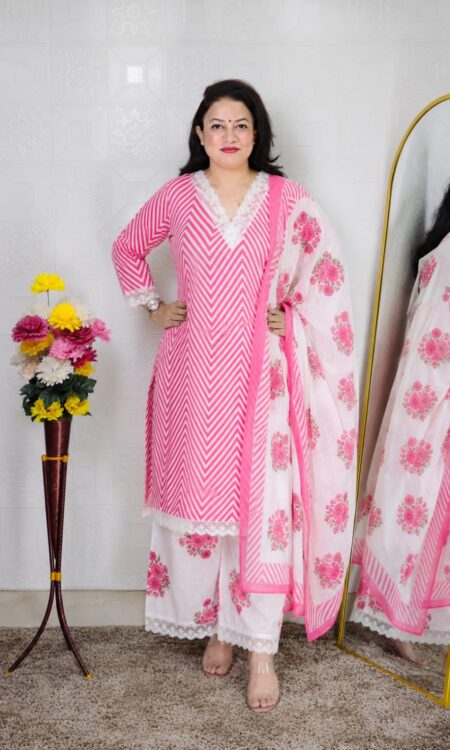 Woman wearing Pink Premium Cotton Straight Kurta Suit Set with Floral Printed Pants, Matching Dupatta and Lace Detailing